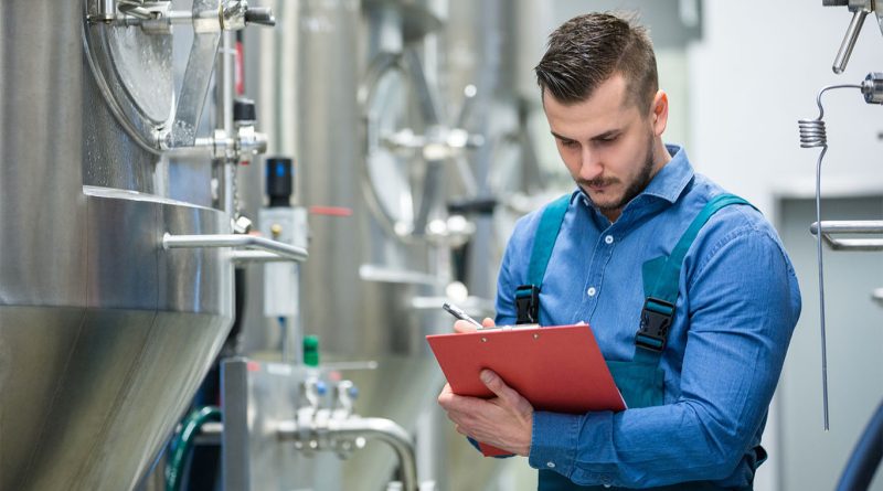 Image of a man looking at a clipboard in a warehouse to support Tre House report article
