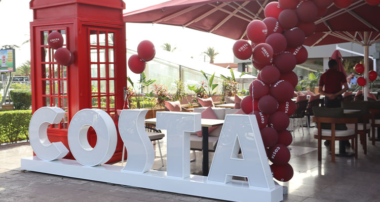 Costa coffee sign with balloons