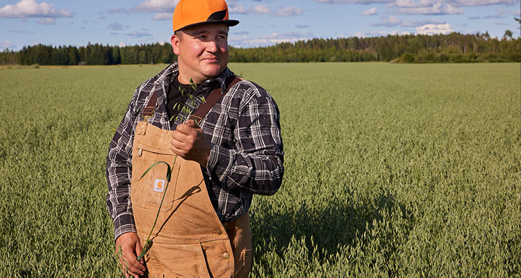 Farmer standing in wheat field