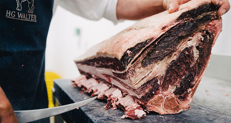 Butcher dressing beef joint